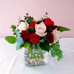 Blush roses with greenery in a cube
